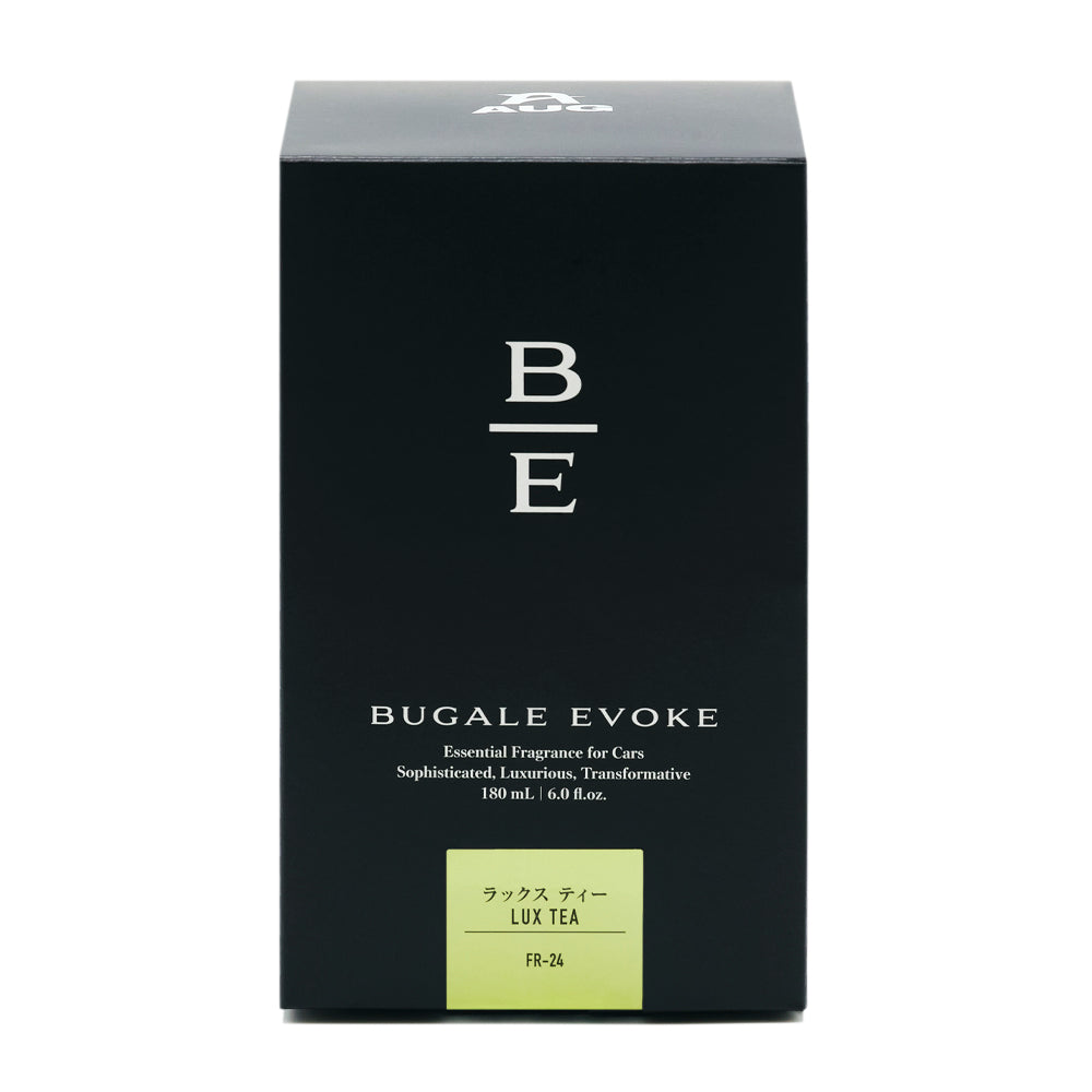 黒い化粧箱の正面。B/Eのモノグラム、BUGALE EVOKE、Essential Fragrance for Cars、Sophisticated, Luxurious, Transformative、180 mL ・ 6.0 fl.oz. の表示。黄緑のラベルに ラックス ティー LUX TEA と品番FR-24