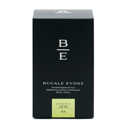 黒い化粧箱の正面。B/Eのモノグラム、BUGALE EVOKE、Essential Fragrance for Cars、Sophisticated, Luxurious, Transformative、180 mL ・ 6.0 fl.oz. の表示。黄緑のラベルに ラックス ティー LUX TEA と品番FR-24